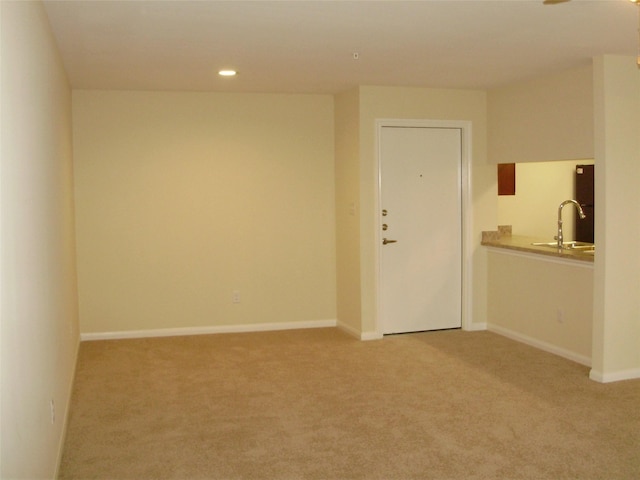 carpeted empty room featuring sink