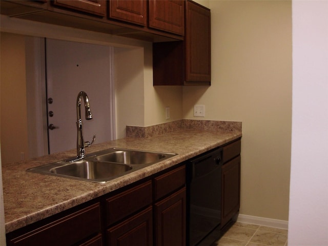 kitchen featuring dark brown cabinets, sink, light tile patterned floors, and black dishwasher