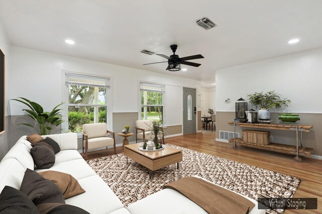 living room featuring hardwood / wood-style floors and ceiling fan