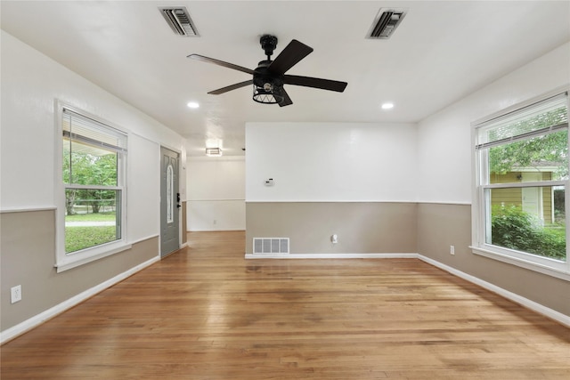 unfurnished room with a wealth of natural light and visible vents