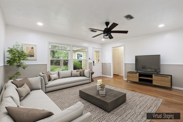 living room featuring hardwood / wood-style floors and ceiling fan