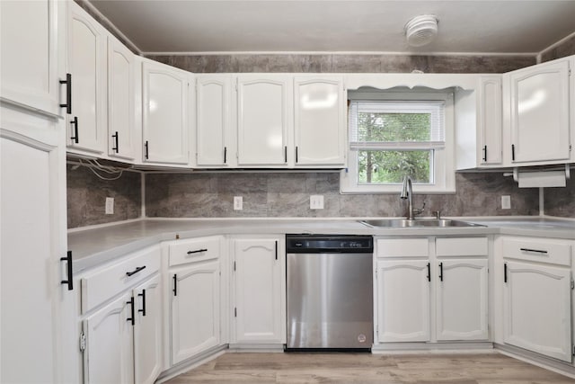 kitchen featuring white cabinetry, sink, stainless steel dishwasher, and light wood-type flooring