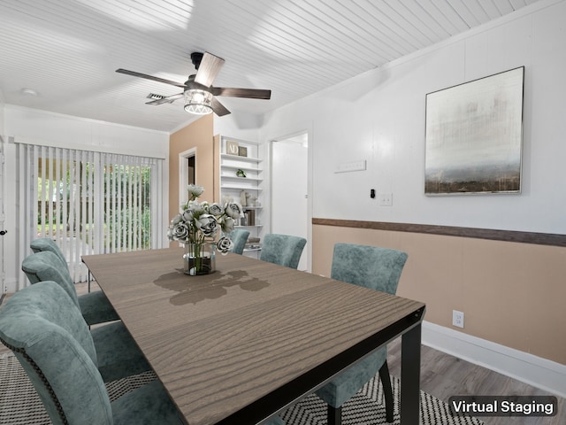 dining area featuring ornamental molding, ceiling fan, hardwood / wood-style flooring, built in features, and a fireplace