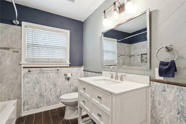 full bathroom featuring vanity, toilet, and tiled shower / bath