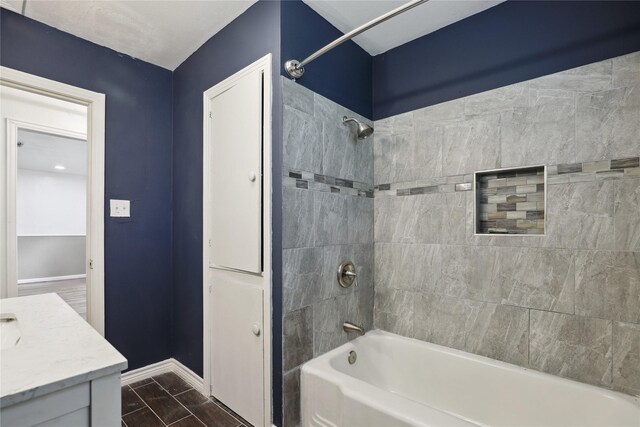 bathroom with vanity and tiled shower / bath combo