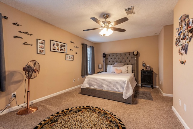 bedroom featuring carpet, ceiling fan, and a textured ceiling