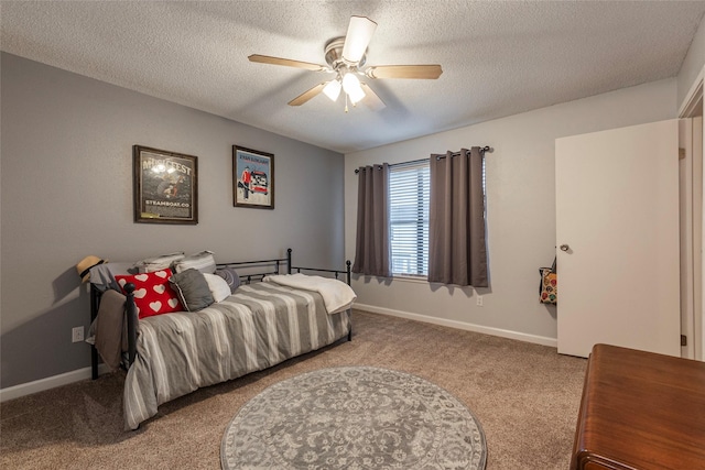 bedroom featuring ceiling fan, light colored carpet, and a textured ceiling