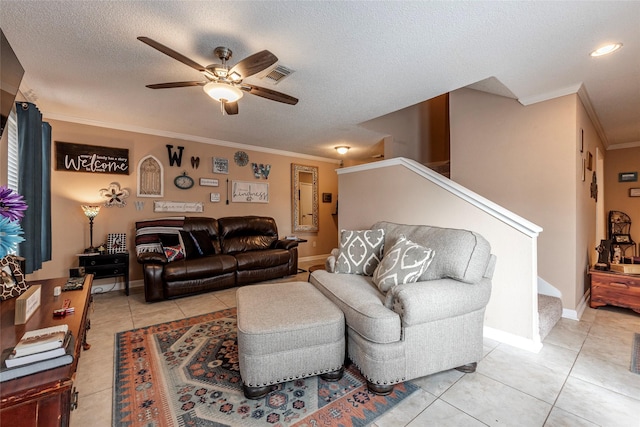 living room with ceiling fan, crown molding, light tile patterned flooring, and a textured ceiling