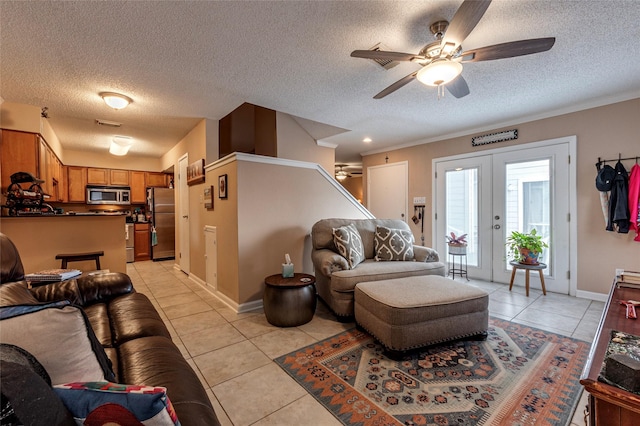 living room featuring ceiling fan, french doors, and light tile patterned floors