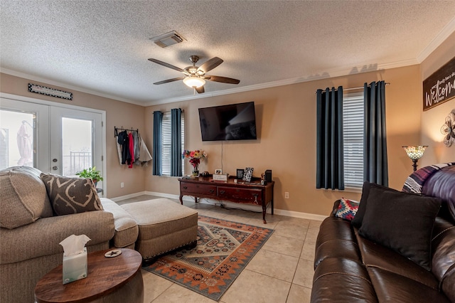 tiled living room featuring ceiling fan, ornamental molding, a textured ceiling, and french doors