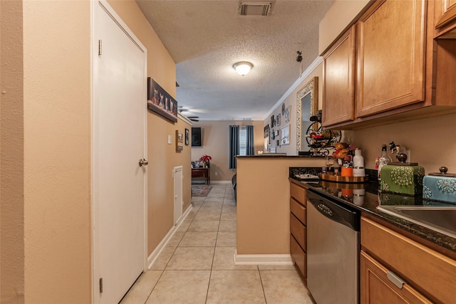 kitchen featuring kitchen peninsula, stainless steel dishwasher, a textured ceiling, sink, and light tile patterned flooring