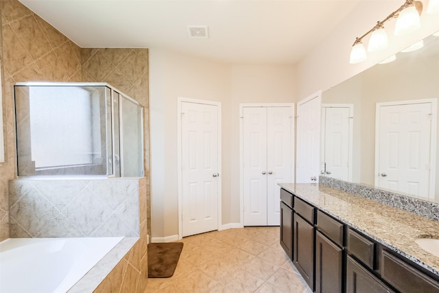 bathroom with tile patterned flooring, vanity, and independent shower and bath