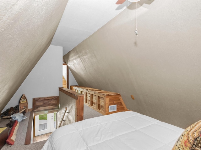 carpeted bedroom featuring ceiling fan and vaulted ceiling