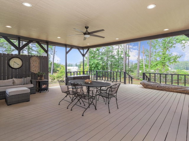 deck featuring outdoor lounge area and ceiling fan