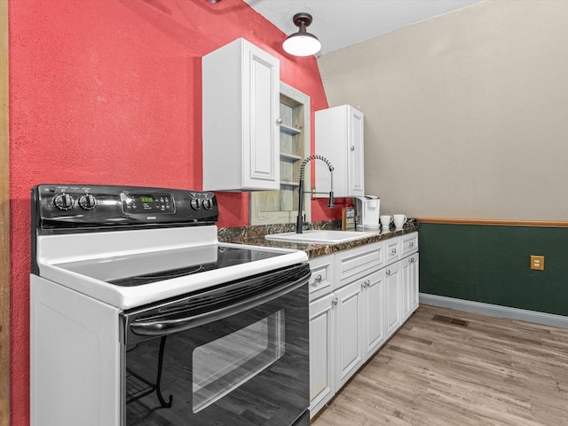 kitchen featuring white cabinets, white electric range oven, sink, and light hardwood / wood-style flooring