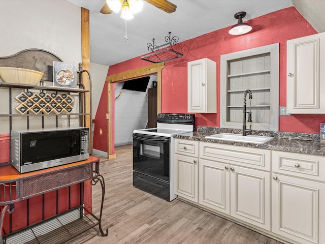 kitchen with light wood-type flooring, black range with electric cooktop, ceiling fan, sink, and white cabinetry