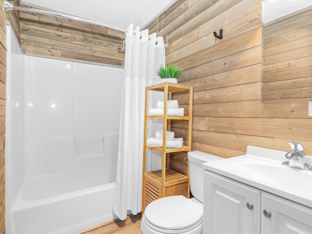 full bathroom featuring wood walls, vanity, shower / tub combo, and toilet