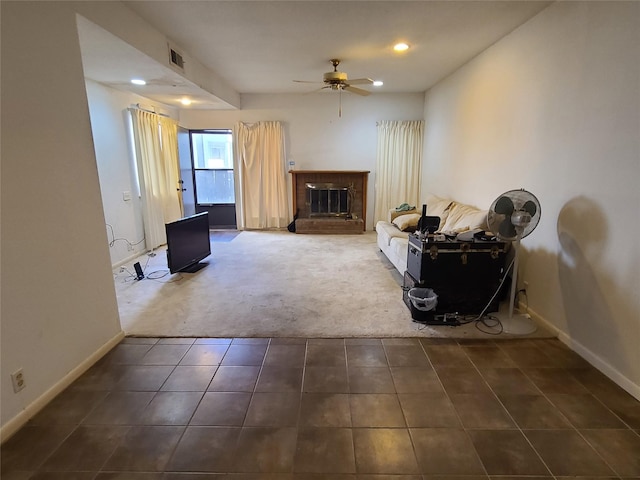 carpeted living room featuring ceiling fan