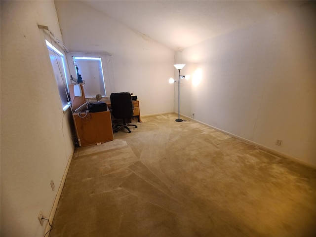 office space with light colored carpet and vaulted ceiling