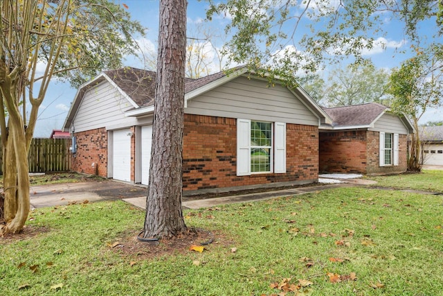 view of front of property with a front yard and a garage