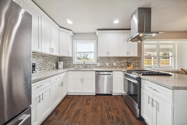 kitchen featuring island exhaust hood, stainless steel appliances, dark wood-type flooring, sink, and white cabinetry