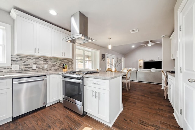 kitchen featuring kitchen peninsula, stainless steel appliances, white cabinetry, and range hood