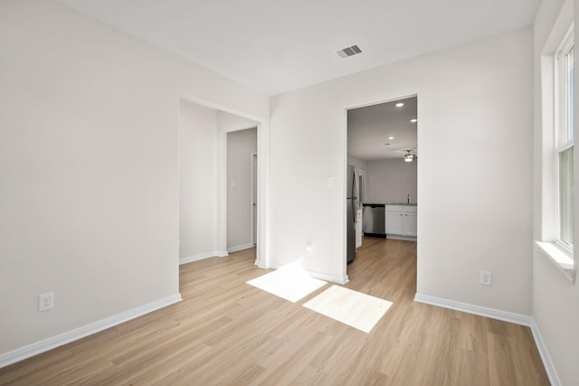 unfurnished room featuring sink and light wood-type flooring