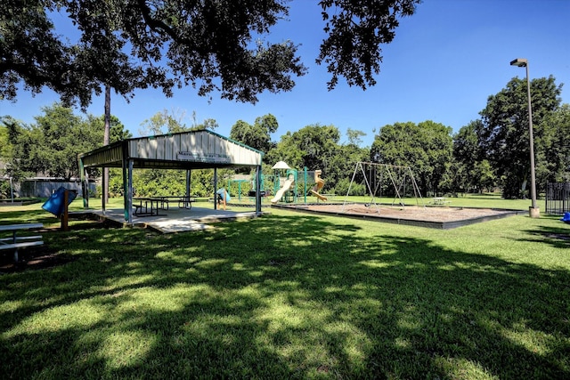 view of home's community featuring a lawn and a playground