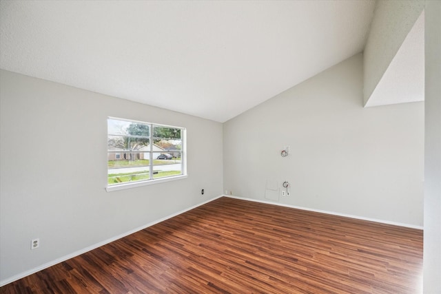 empty room with hardwood / wood-style floors and vaulted ceiling