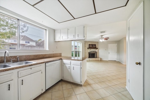 kitchen featuring white dishwasher, white cabinets, and sink