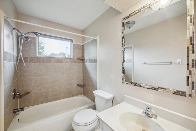 full bathroom with tiled shower / bath combo, toilet, and vanity