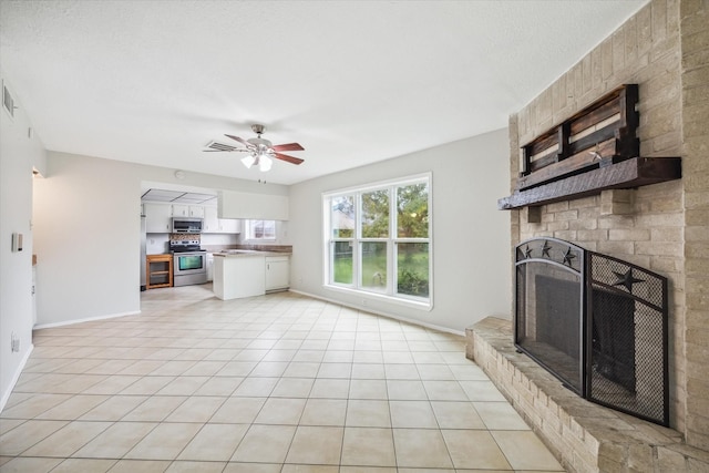 tiled living room featuring a fireplace and ceiling fan