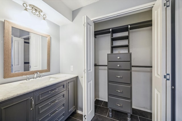 bathroom with tile patterned floors and vanity