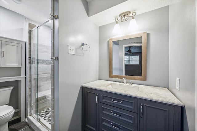 bathroom with vanity, toilet, and a shower with shower door