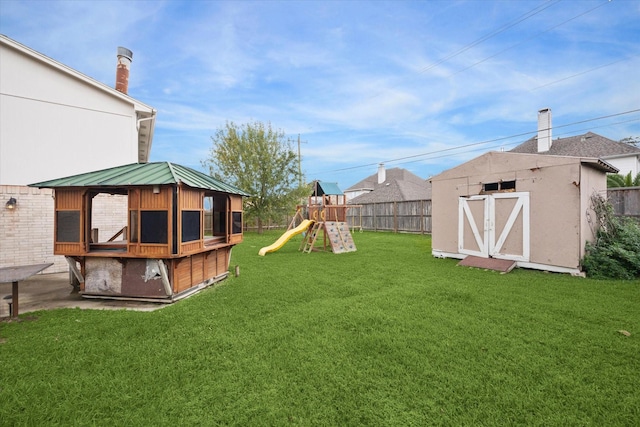 view of yard with a playground and a storage unit