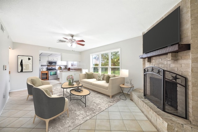 tiled living room with ceiling fan and a fireplace