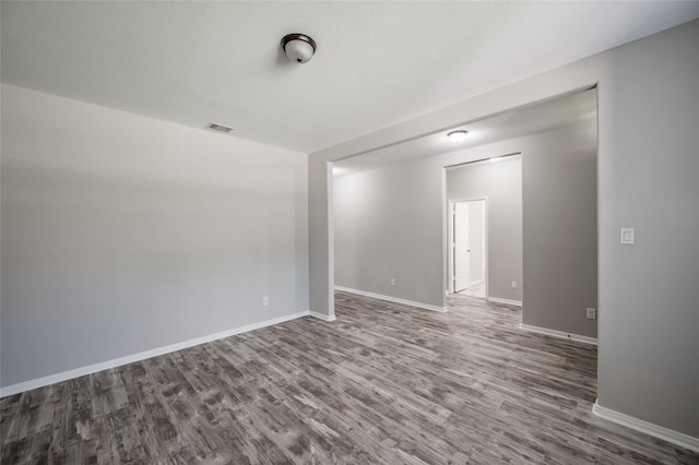 spare room with hardwood / wood-style floors