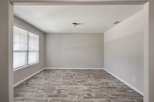 empty room featuring hardwood / wood-style flooring