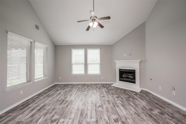 unfurnished living room featuring hardwood / wood-style floors, vaulted ceiling, and ceiling fan