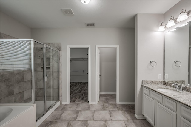 bathroom featuring vanity and separate shower and tub