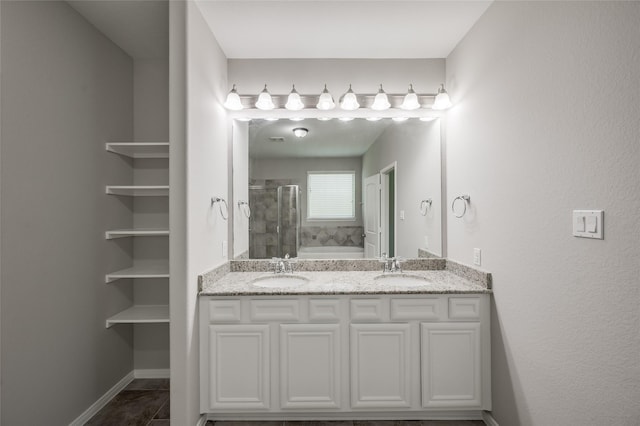 bathroom featuring tile patterned floors, vanity, and a shower with shower door