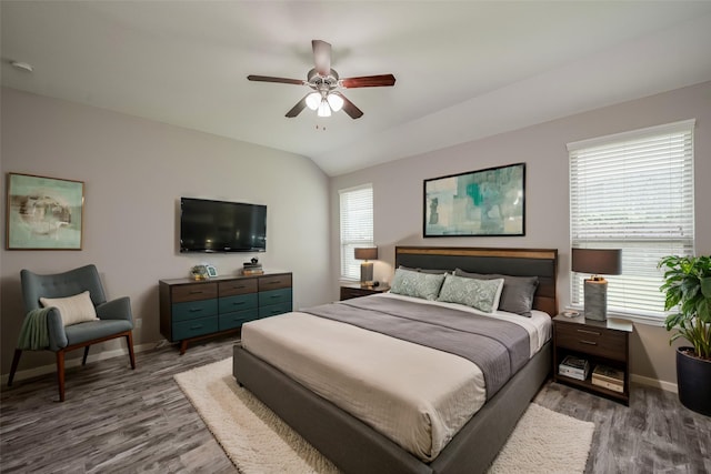 bedroom featuring ceiling fan, light hardwood / wood-style floors, lofted ceiling, and multiple windows