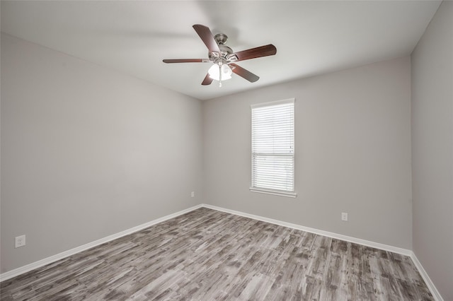 spare room with ceiling fan and light wood-type flooring