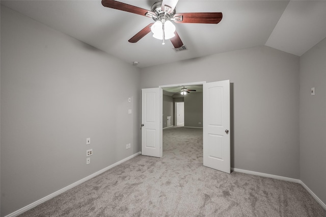 unfurnished bedroom with ceiling fan, light carpet, and lofted ceiling