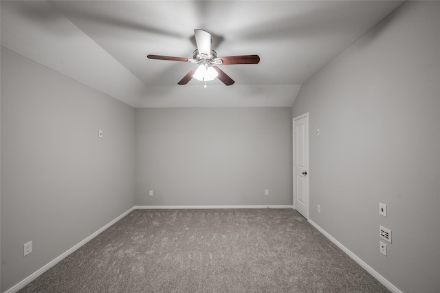 spare room featuring carpet flooring, ceiling fan, and lofted ceiling