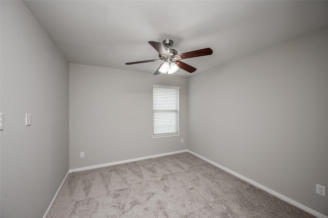 unfurnished room with ceiling fan and light colored carpet