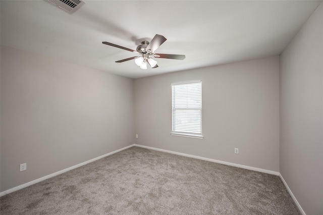 spare room featuring ceiling fan and light colored carpet