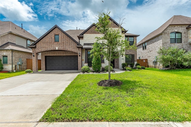 view of front of property with a front yard and a garage