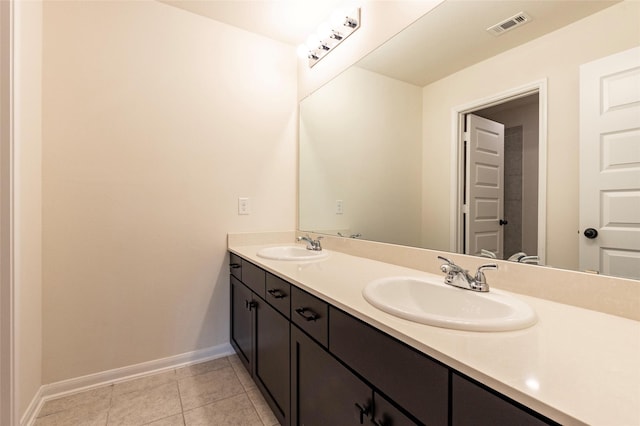 bathroom with tile patterned floors and vanity