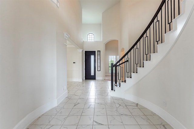 entryway with a towering ceiling